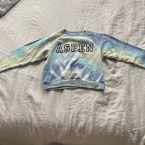 Tie dye jumper with the name “Aspen” in it.